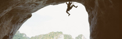 Silhouette of a Man Climbing a Rock, Railay Beach, Krabi, Thailand Poster