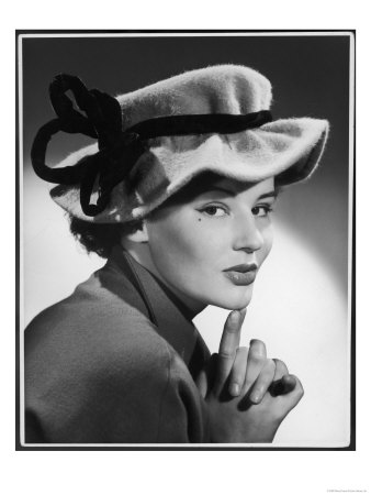 Woman Wears a Felt Hat Which Has a Felt Ribbon Tied Around It