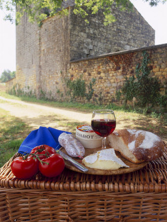 Picnic Lunch of Bread, Cheese, Tomatoes and Red Wine on a Hamper in the Dordogne, France