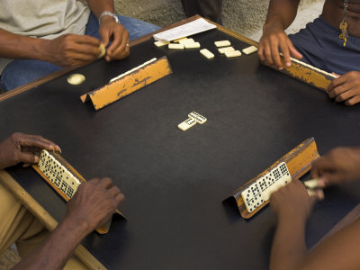 The Hands of a Group of Four People Playing Dominos in the Street Centro Habana