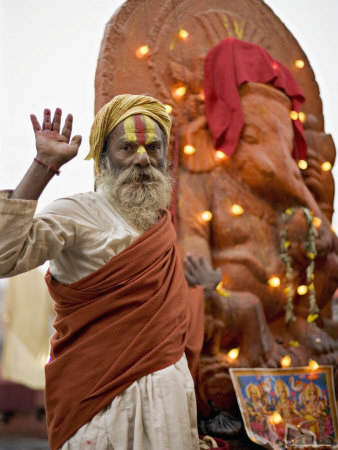 Holy Man in Front of a Ganesh Statue Draped in Fairy Lights at the Hindu Festival of Shivaratri