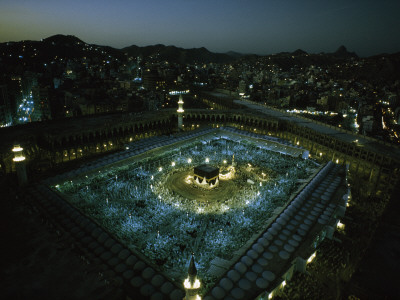 Thousands of pilgrims circle the Kaaba in illuminated view at night