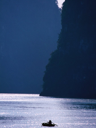 Woman Navigates Among Magnificent Limestone Islands of Halong Bay, Halong Bay, Quang Ninh, Vietnam
