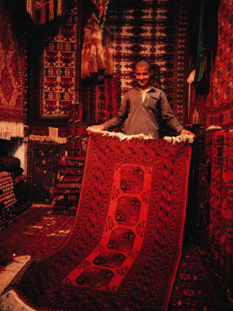 Carpet Trader Displaying a Woolen Carpet, Peshawar, North-West Frontier Province, Pakistan