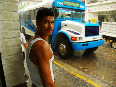 Man Waits for Bus in Torrential Tropical Downpour in Zona Centromexico