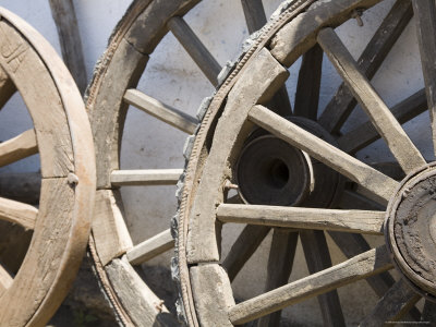 Buy Old Wooden Wagon Wheels Leab against a Whitewashed Wall at AllPosters.com