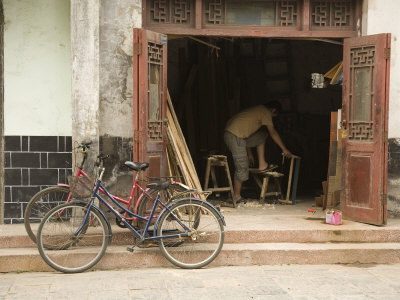 Buy Two Bicycles Parked in Front of Woodworker's Shop, Jingzhou, China at AllPosters.com