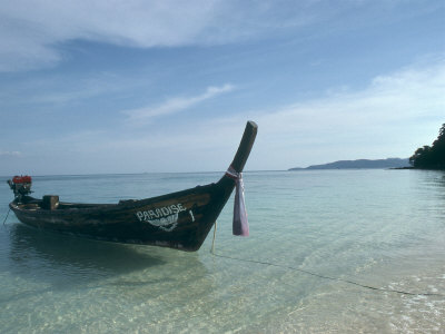 Buy Wooden Boat Named Paradise is Tethered to a Palm Tree at AllPosters.com