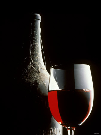 Glass of Red Wine with Aged Bottle, Cobwebs