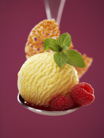 A Scoop of Vanilla Ice Cream with Hot Raspberries on a Spoon