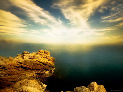 Sunlight Reflecting off Blue Waters off Cliffside