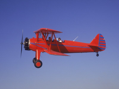 Red Bi-Plane in Flight