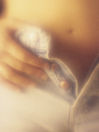 Close-up of Woman's Hands Buttoning Blue Jeans