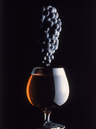 Bunch of Grapes Over a Glass of Wine
