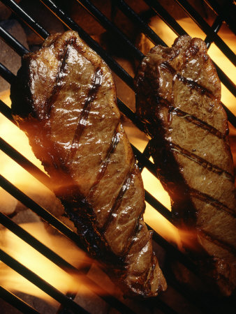 Steaks Cooking on Grill