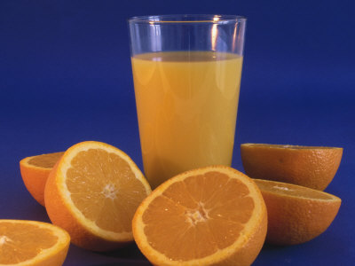 Glass of Juice and Oranges