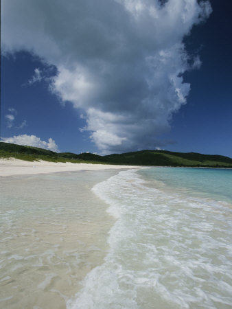 A Strip of Cumulous Clouds Follows This Receding, Tropical Shoreline
