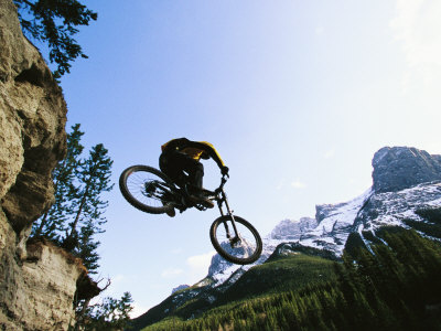 Buy Man Jumping on His Mountain Bike with Ha Ling Peak in the Background at AllPosters.com