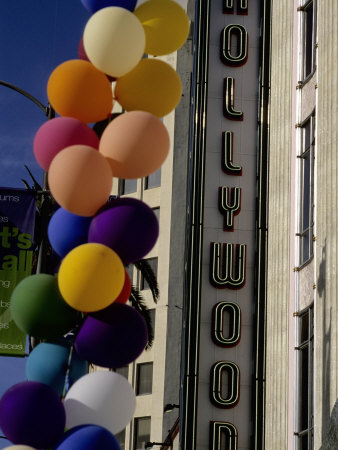 Multi-Colored Balloons and a Neon Sign Welcome Visitors to Hollywood