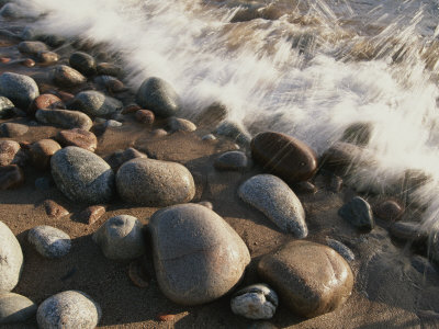 Buy A Close View Time Exposure of Surf Washing over Stones on the Beach at AllPosters.com