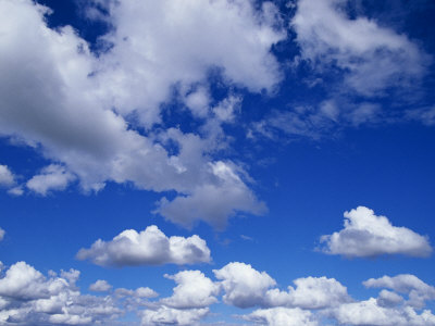 Buy Sunlit Fluffy White Clouds in a Blue Sky at AllPosters.com