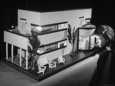 Little Girl Looking Into a Modern Doll House Being Sold at F.A.O. Schwarz