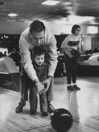 Dad Showing 3 Year Old Daughter the Basics of Bowling Poster