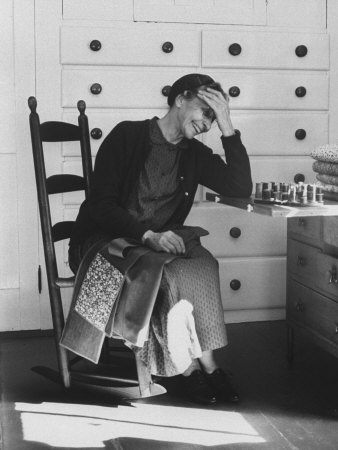Sister Mildred Laughing with Hand to Head in Sewing Room of Her Small Shaker Community
