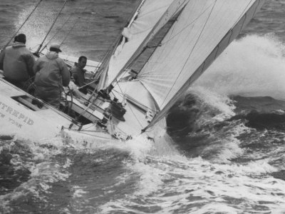 The Intrepid Tipping Into a Sharp Wave Poster