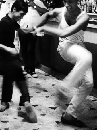 Two Young Italian Men Dancing to Music from a Jukebox in a Bar