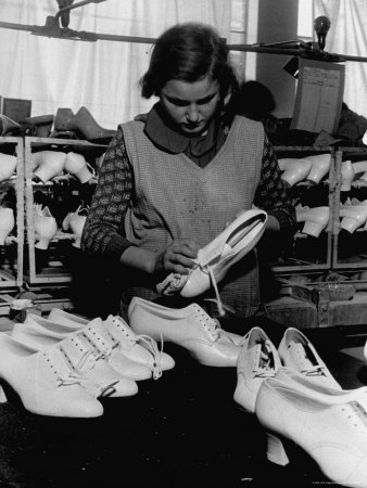 Woman Polishing the Shoes Before Packing Them