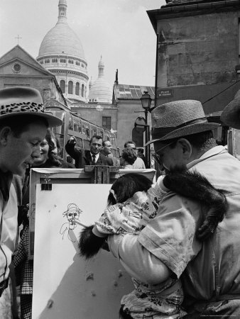 Street Artist Holding a Monkey Up to a Canvas So It Can Draw