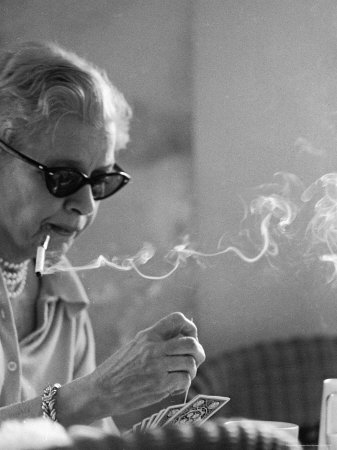 Older Woman Smoking and Playing Cards at the Cannes Film Festival