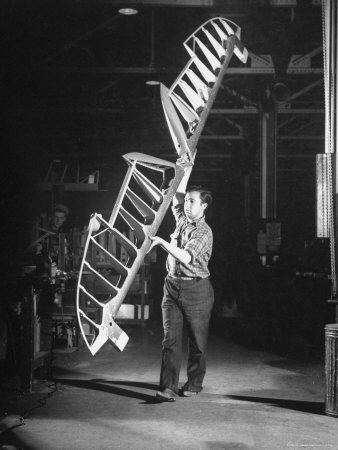 Worker Carrying Elevator Frame, at Curtiss Wright Plant