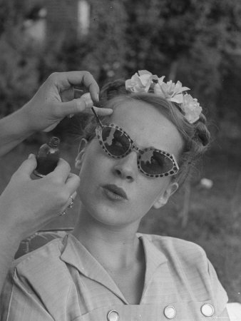 Teenage Girl Having Nail Polish Touches Added to Her Sunglasses