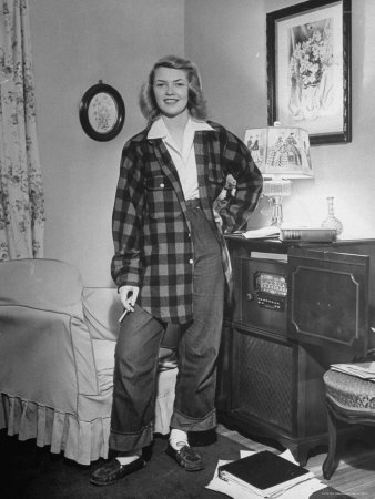 Teenage Girl Wearing Blue Jeans and Large Checkered Shirt Which is Usual After School Costume