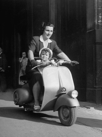 Mother and Baby Riding a Vespa Scooter