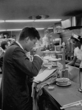 Senator John F. Kennedy Drinking a Cup of Coffee at a Cafe in Washington Airport