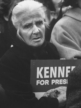 Old Woman Holding a Kennedy Poster