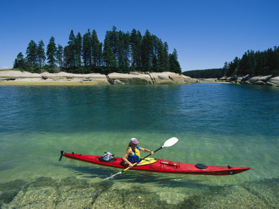 Woman Kayaks Through the Clear Water of Penobscot Bay, Maine