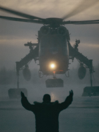 Buy A Man Guides a Landing Helicopter at AllPosters.com