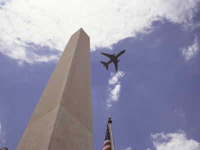 Plane Flying above Washington Monument and United States Flag