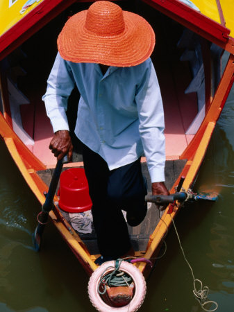 Helmsman Manoeuvres Sampan or Ferry on Sarawak River, Kuching, Sarawak, Malaysia