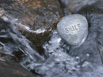 Rock with the Word Smile in Rushing Water