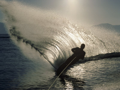 Waterskier Silhouetted with Sun Shining Through Water