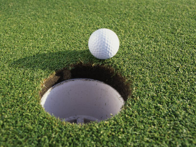 Close-up of a Golf Ball Near a Hole Poster