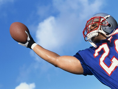 Low Angle View of An American Football Player Catching a Ball Poster