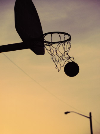 Silhouette of a Basketball Going Through a Basketball Net Poster