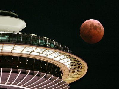 The Full Moon Turns Red and Orange as It Passes the Space Needle