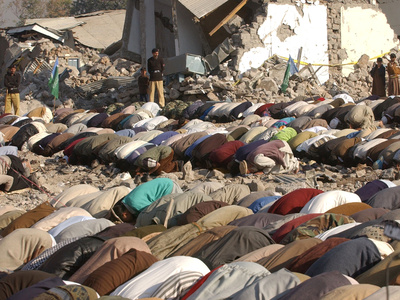 Kashmiri Eartquake Survivors Pray Amid the Debris of a Destroyed Building During the Eid Al-Fitr